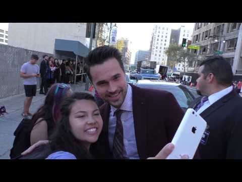 Brett Dalton greets fans while arriving at the American Ultra Premiere at Ace Hotel in Los Angeles