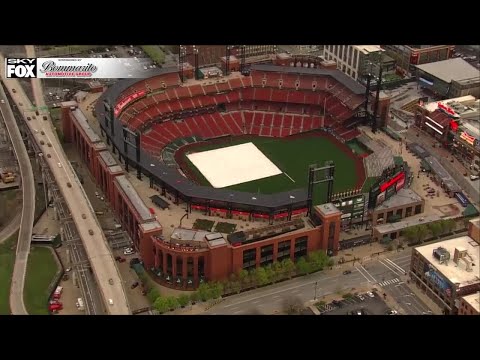 Busch grounds crew rolling up tarp