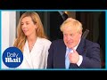 Boris and Carrie Johnson walk hand in hand as they arrive at G7 summit