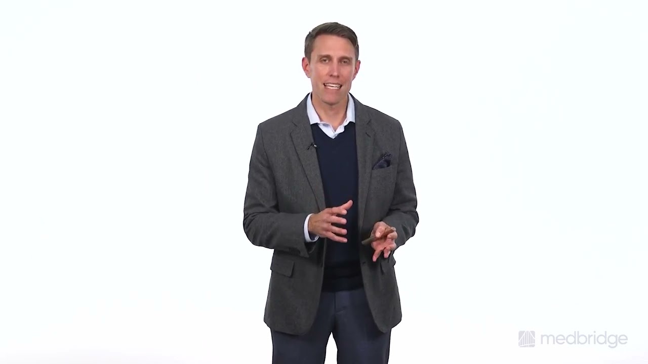 A man speaks about digital healthcare in front of a white background, referencing medbridge.