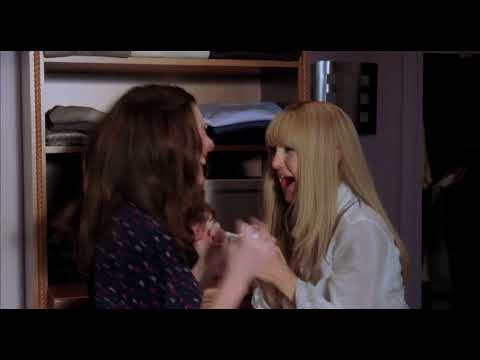 Trailer frame: the best friends in wedding gowns about to walk—mirrored doors moment