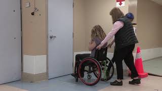 Manual Wheelchair Skill: Gets through hinged door, training with caregiver