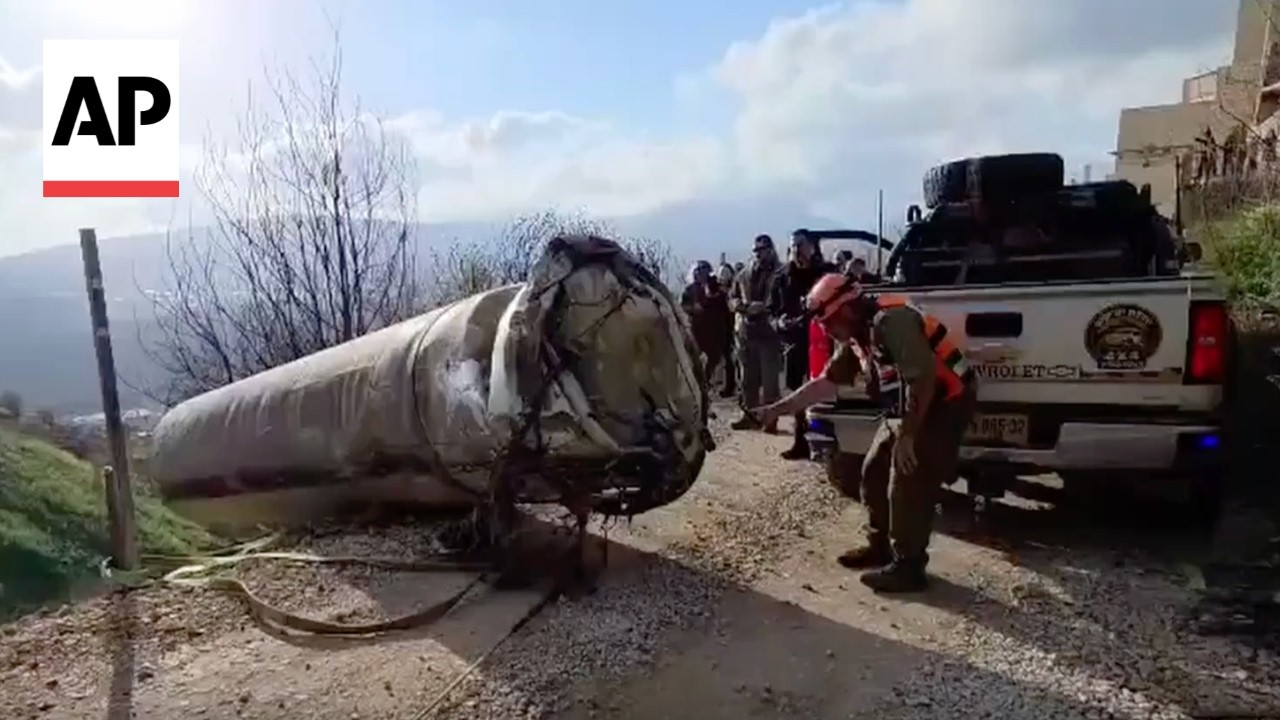 Video | Crew remove a large Iran missile fragment from a road in Israel