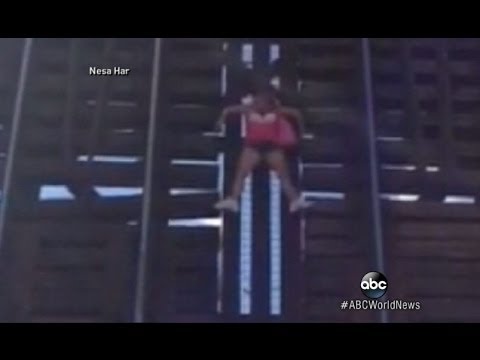 Woman Clings for Life on Rising Railroad Bridge