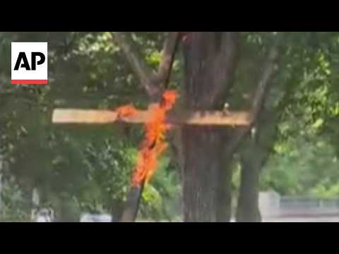 Police are investigating a large burning cross at a Chicago park