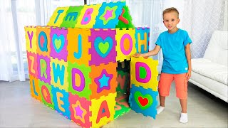Vlad and Nikita pretend play and build colored Playhouse