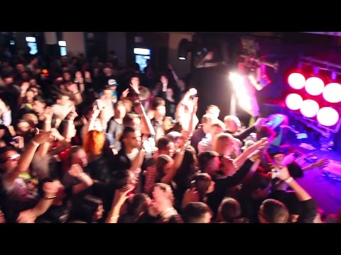 Night clubbers groove in strobe light splashes on dance floor. Stock Footage