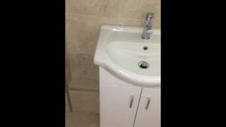 Cloakroom with natural stone tiles