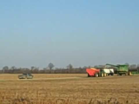 Combine unloading soybeans into truck outside New Harmony, IN