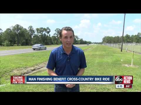 Man finishing benefit cross country bike ride