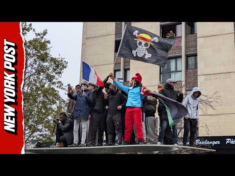 French Protesters Climb on Top of Bus Stop and Demand Macron's Resignation
