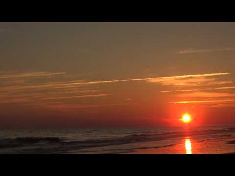 Watching a beautiful orange sunset over the ocean