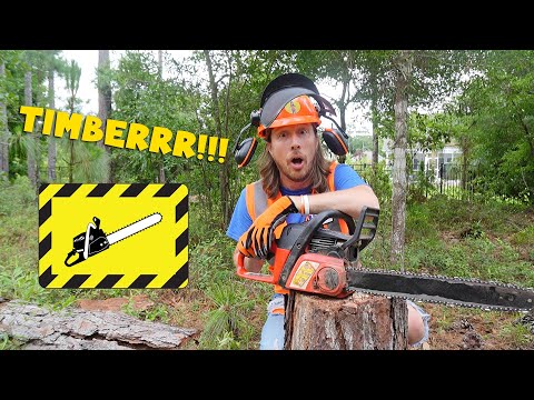 Man in safety gear with a running chainsaw cutting a log in a forest setting, surprised expression on his face.