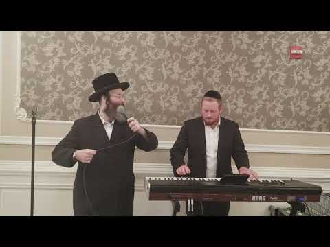 Shmuel Dovid Mezei with R Shloime Taussig starting second dance at a wedding