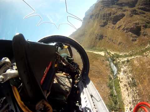 Buccaneer flying through the mountain valleys just a few feet from valley floor and mountain sides