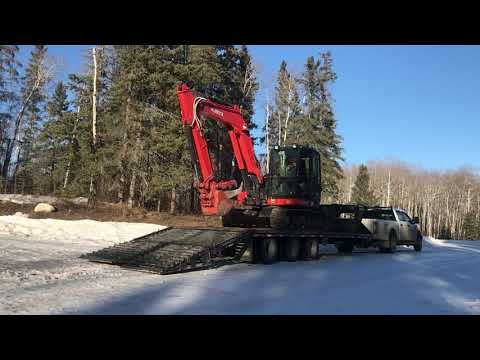 Unloading kubota excavator off trailer