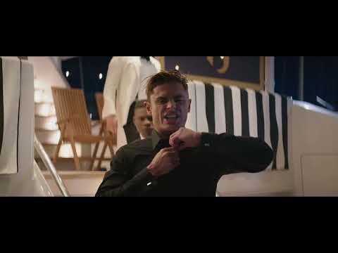 Close-up action beat in the trailer: spray, sun flare, and a hard cut that rides an electronic downbeat