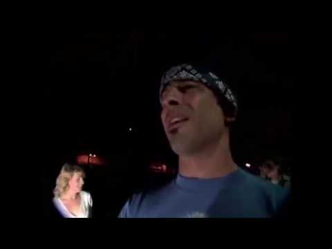 Trailer still: handheld docu look following band gear through a backstage corridor