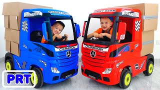Vlad e Nikita fingem brincar com caminhões para crianças