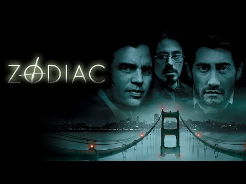 Zodiac trailer frame showing newsroom bustle under period radio and print ephemera
