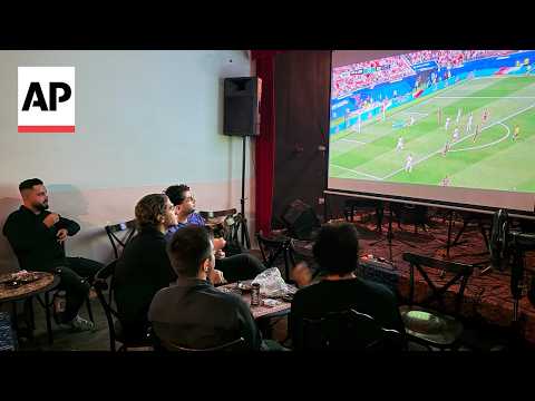 Fans watch Iran's first World Cup match at a coffee shop in Tehran