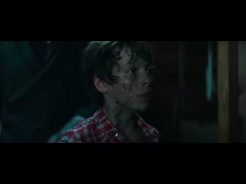 Sinister 2 trailer frame highlighting projector light through dust as the boys watch a reel