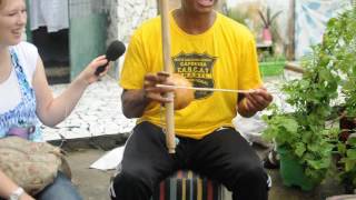 Capoeira Maestre Caboclinho plays the berimbau