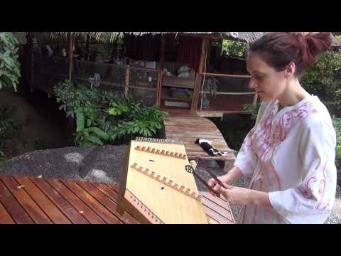 Dizzi Playing the Sanctuary music on a chilled medieval dulcimer in Thailand