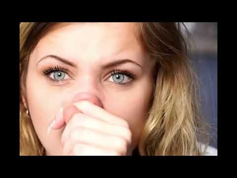 Close-up of a blonde woman blowing her nose