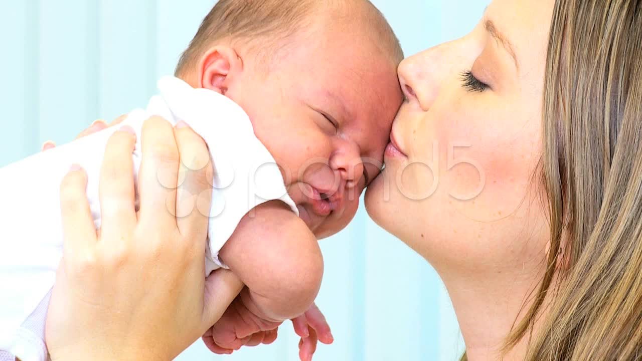 Portrait Mother Kissing Baby Daughter. Stock Footage