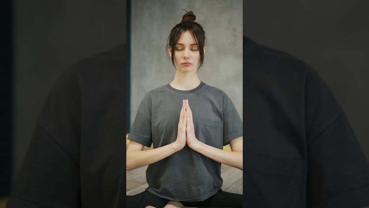 A WOMAN MEDITATING IN LOTUS POSITION