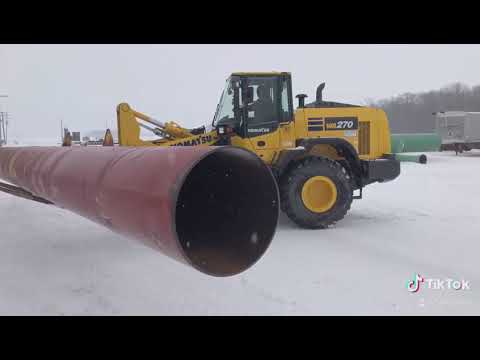 Unloading some large steel pipe in the snow