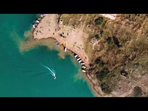 Drone Video Of Coastal Green Mountains And A Sandy Beach
