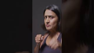 Mature Woman Wearing Gym Fitness Clothing Exercising Sparring At Camera