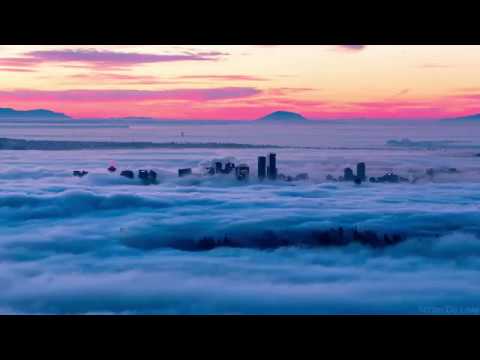 Fog flowing around Vancouver at Sunrise