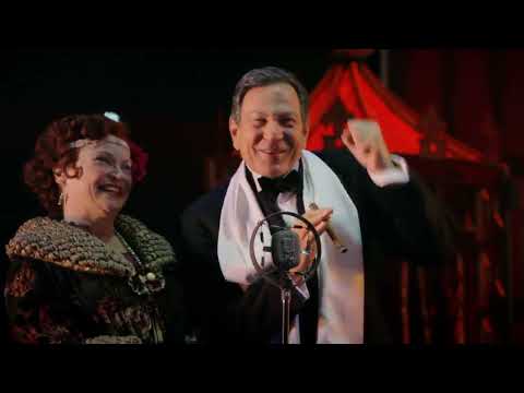 Trailer frame with chorus line umbrellas and bright marquees during Broadway Melody sequence