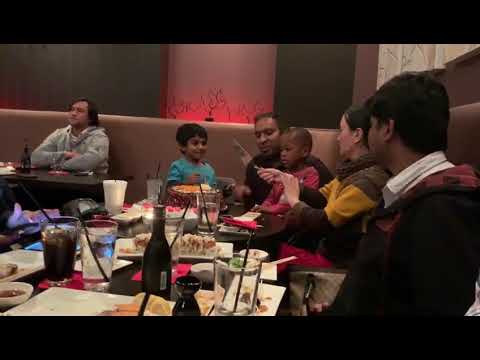 Rishik cutting cake along with his dad