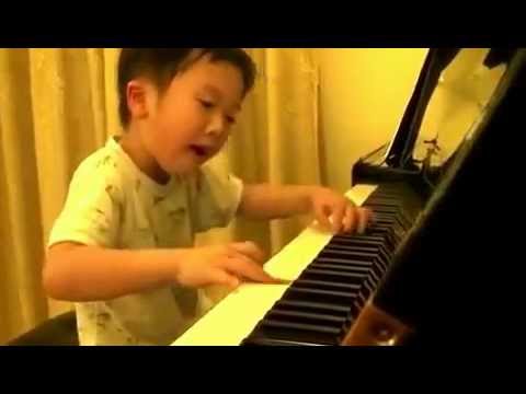 Five years old boy playing astonishing piano