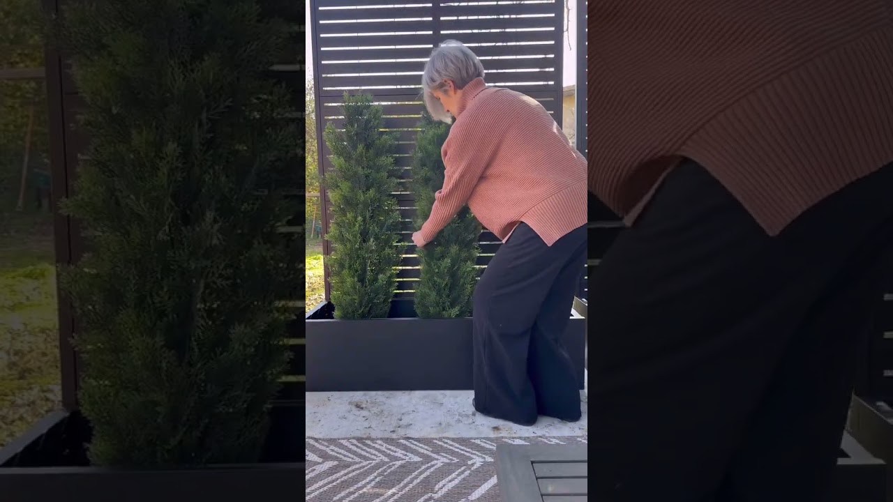 These metal planter boxes with tall slatted trellises offer the perfect edge to a patio, provide