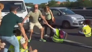 Furious drivers physically drag activists off a busy highway