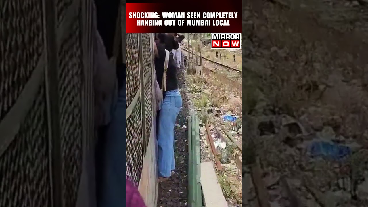 Viral Video | Woman Completely Hangs Out Of Moving Mumbai Local | #shorts