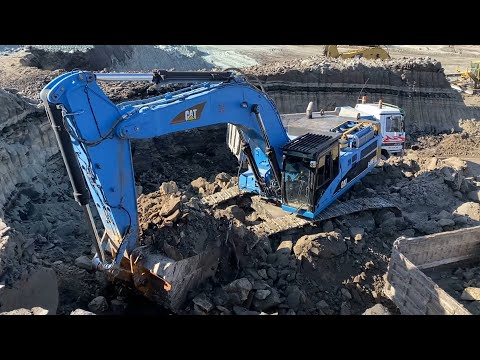 Blue Caterpillar 345C Excavator Loading Trucks