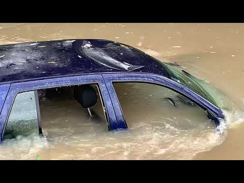 Receding river levels following flooding reveal submerged car in the Heathcote River