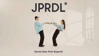 Kadr z teledysku JPRDL tekst piosenki Sarsa Markiewicz feat. Piotr Rogucki