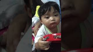 Baby JD playing tambourine toy