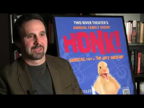 HONK! company lined across the stage in a rhythmic clap-and-stamp section