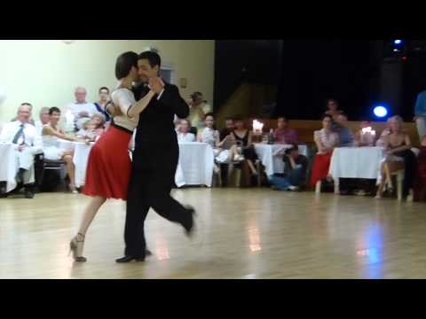  Adrian Costa  and  Amanda Costa  are  dancing  to  a  milonga