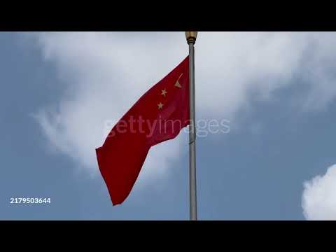 Chinese National Flag Waving Against a Cloudy Sky – Symbol of Pride & Unity.