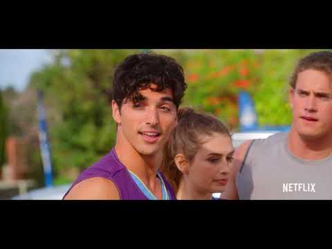 Final trailer beat: Elle rides pillion on a scooter at sunset as the cue drops to softer pads