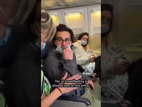 A WOMAN BREASTFEEDING A CAT ONBOARD AN AIRPLANE